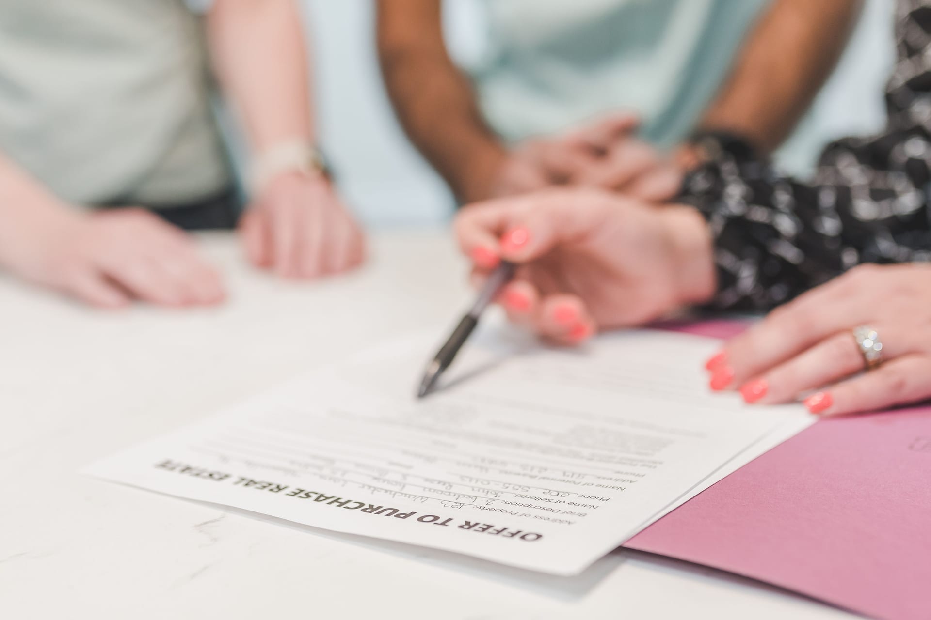 A buyer and advisor reviewing the OTP and S&P paperwork at the table
